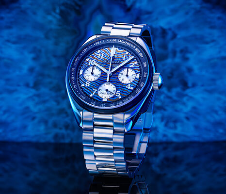 Bulova men’s chronograph watch with blue dial and stainless steel bracelet, tachymeter bezel and three sub-dials.